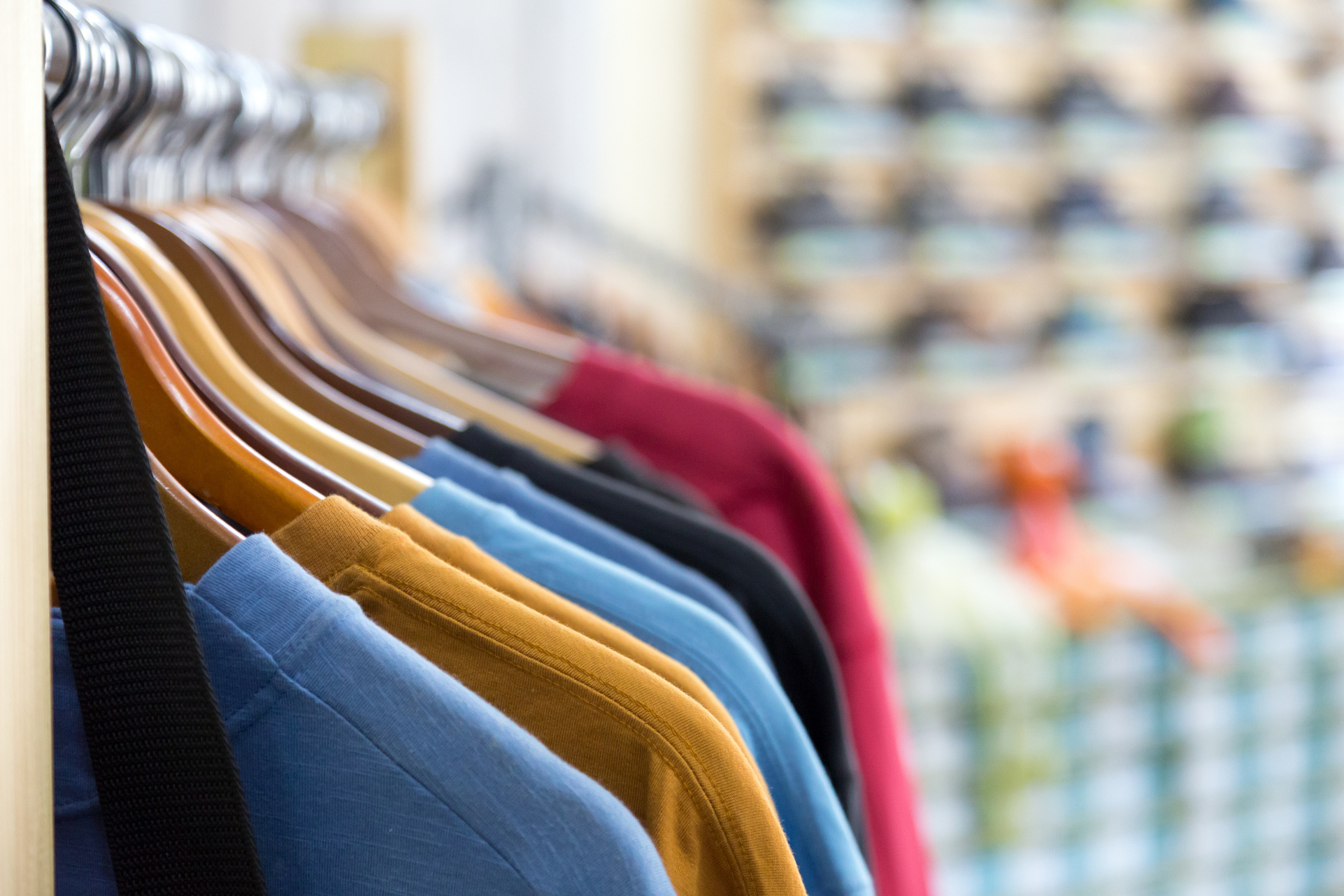 Row of Summer Seasonal Apparel on Hangers of Retail Shop