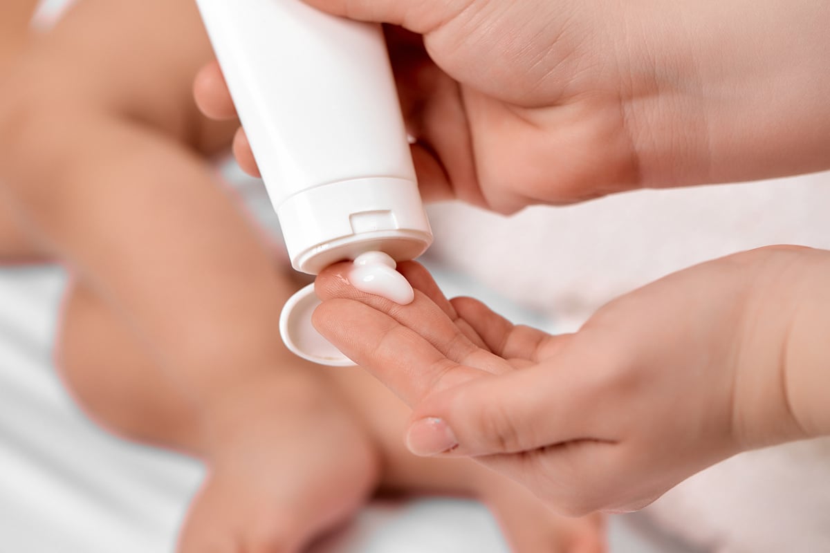 Parent Applying Lotion on Their Baby